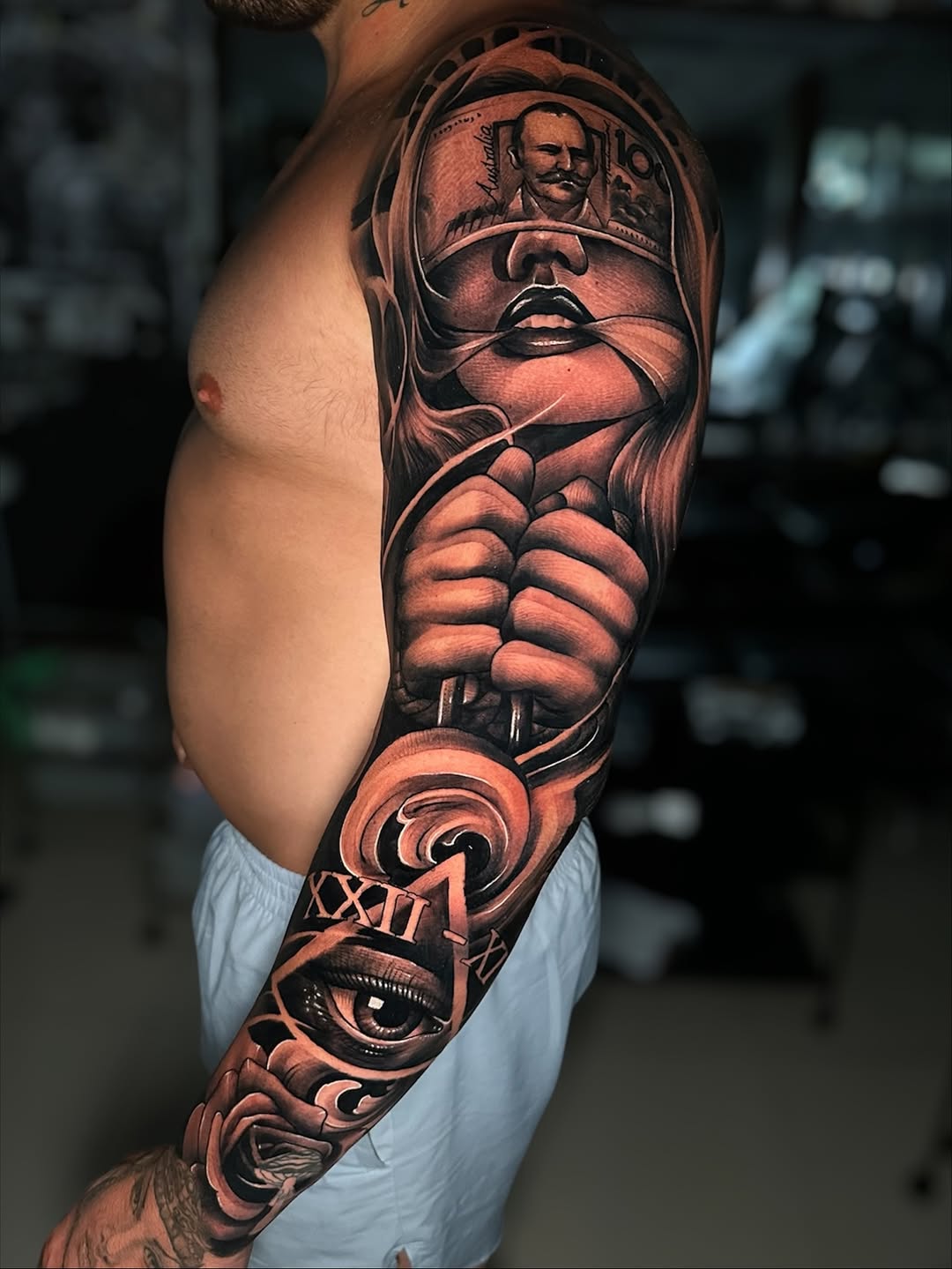 Dramatic black-and-gray sleeve with surreal portrait and eye