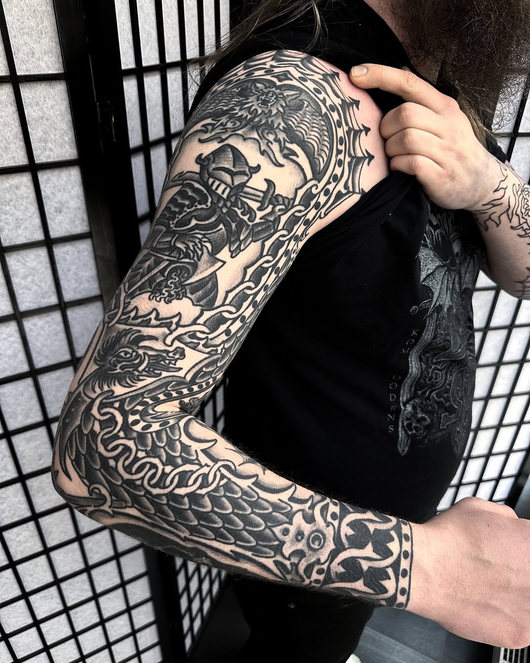 Bold blackwork dragon-sleeve with chain accents.