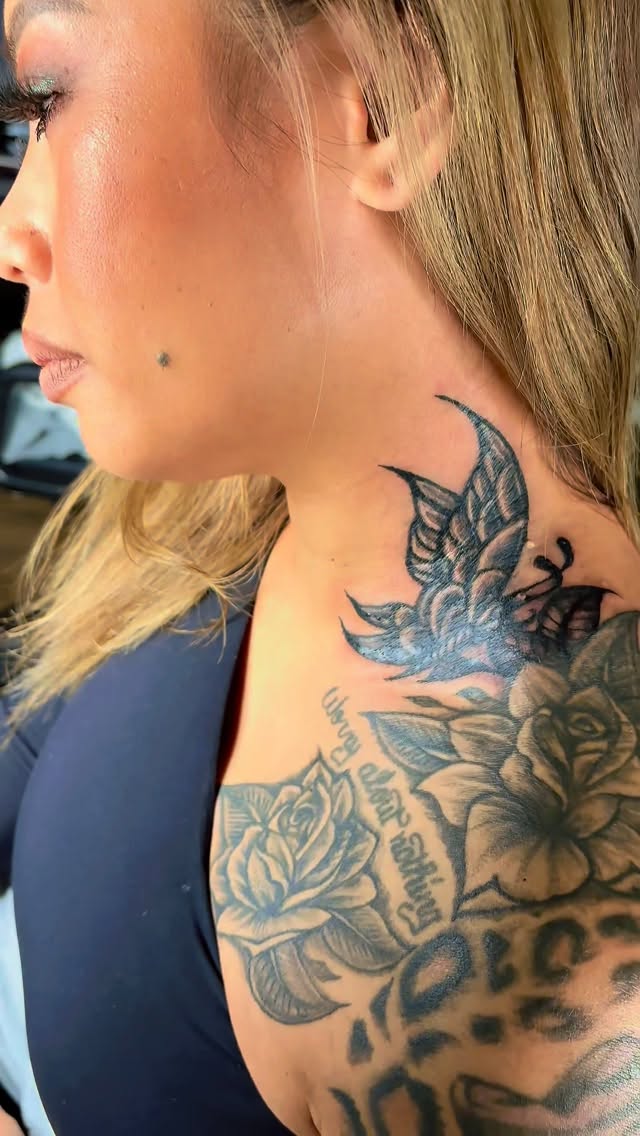 Bold floral neckpiece with delicate script detailing