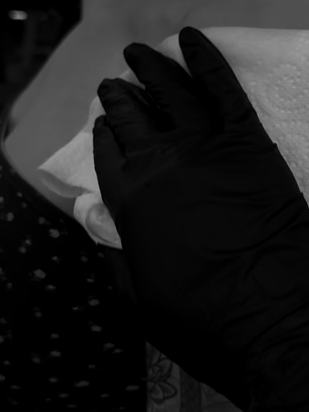 Delicate fineline floral forearm tattoo with subtle shading