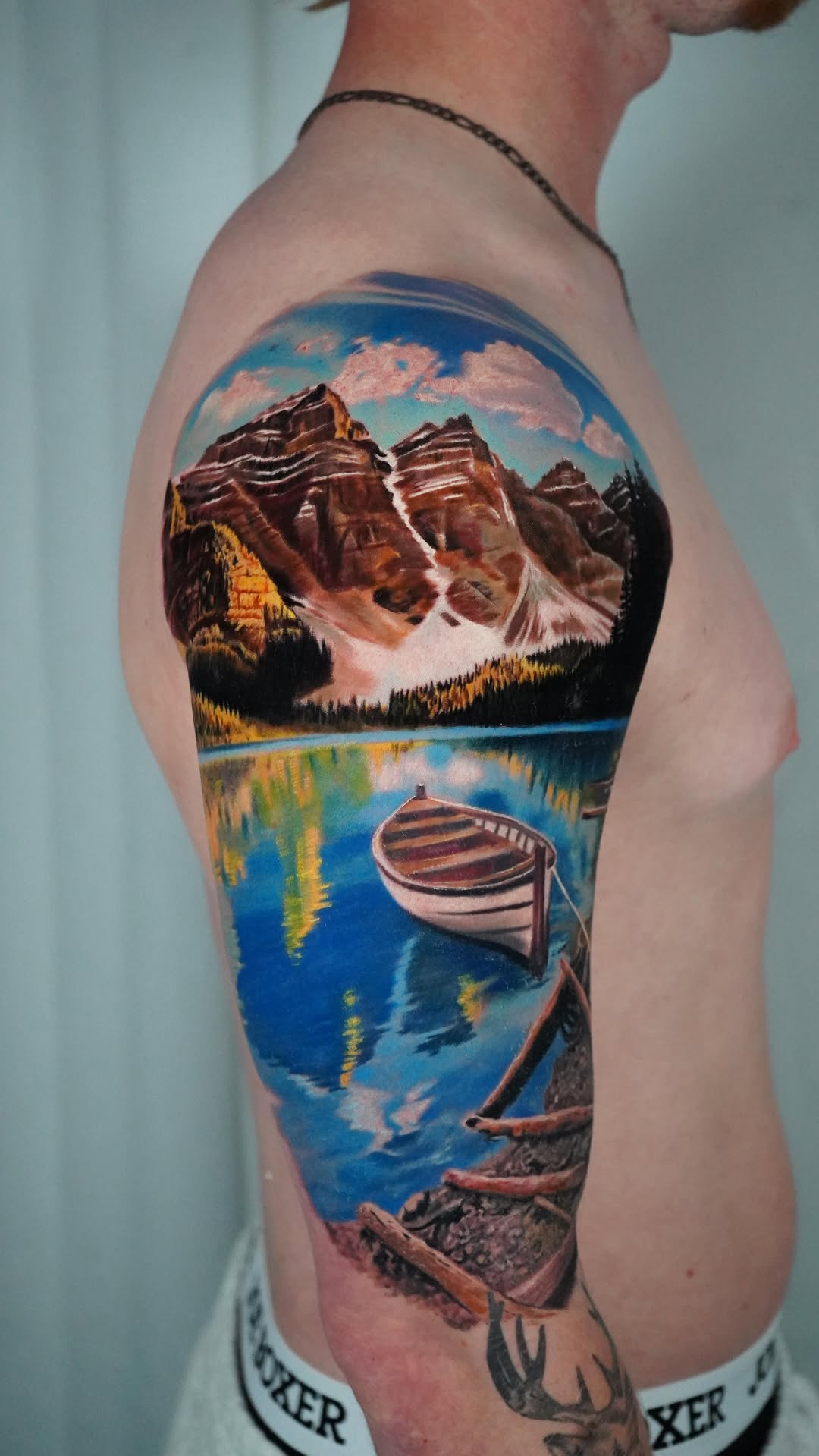 Vibrant mountain-lake landscape sleeve with boats