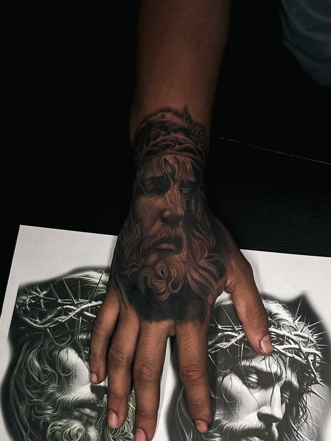Hyper-detailed black-and-gray Jesus portrait with crown of thorns on forearm