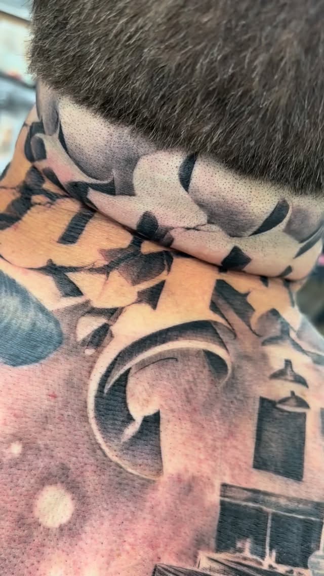 Bold blackwork neck piece with interlocking geometric shapes