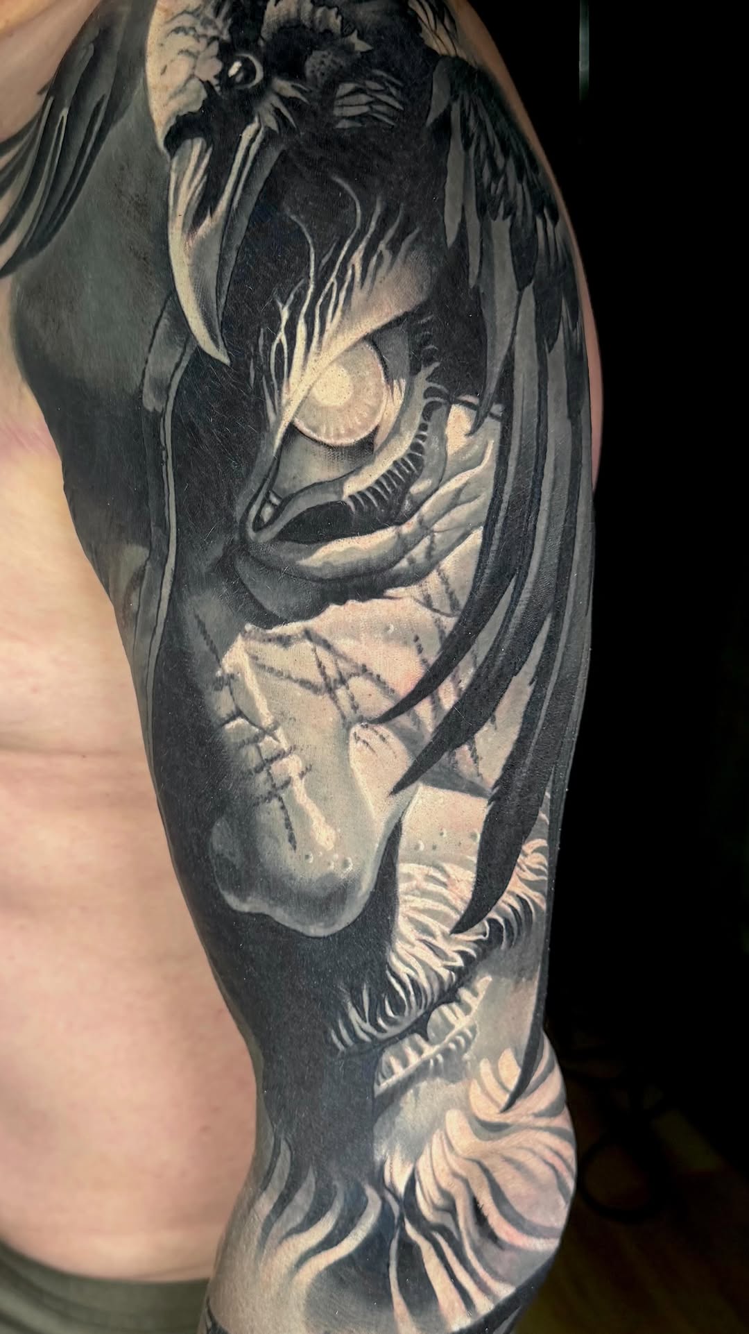 Monochrome dragon head with flowing tendrils and bold shading