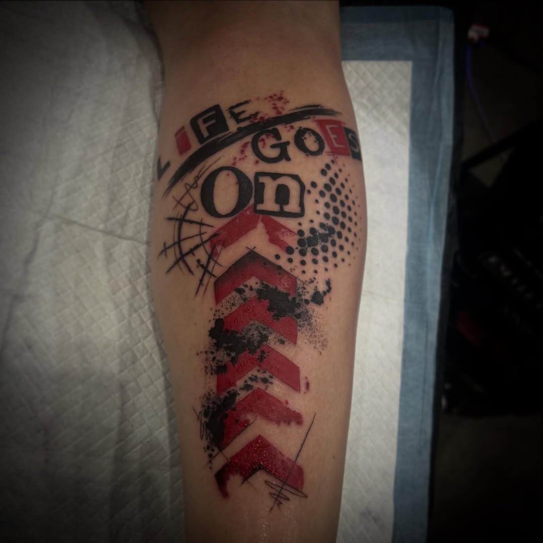 Bold abstract geometric forearm piece with red chevrons