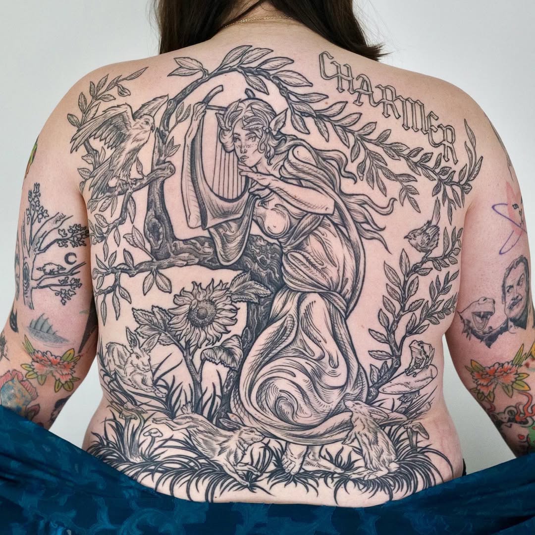 Engraving-style back piece featuring ethereal female with harp and flora
