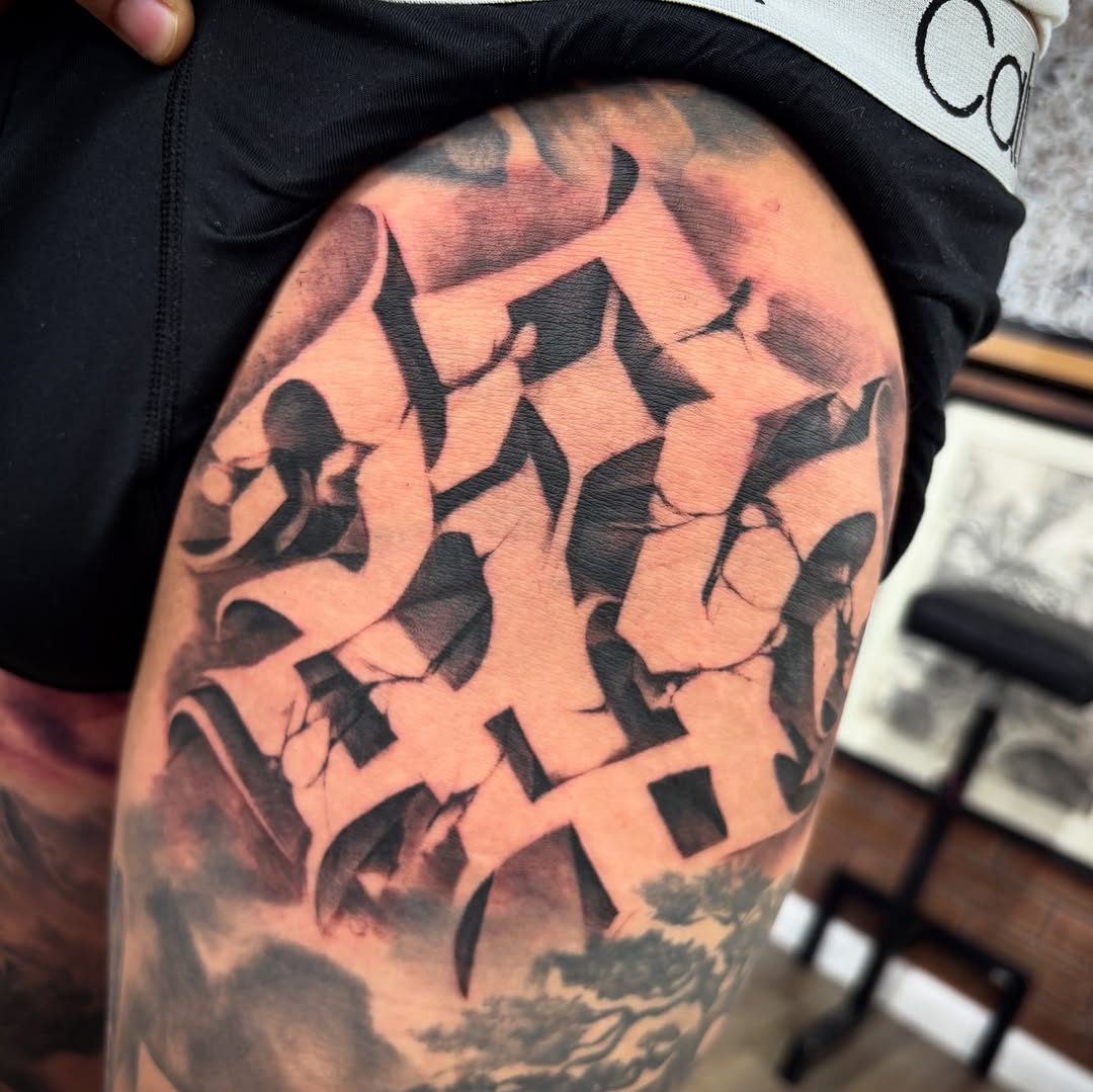 Bold black monogram lettering with fractured geometric shards