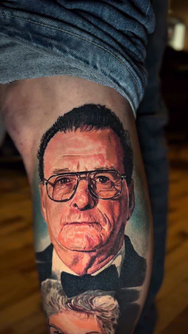 Hyper-realistic portrait tattoo with bold shading and glasses