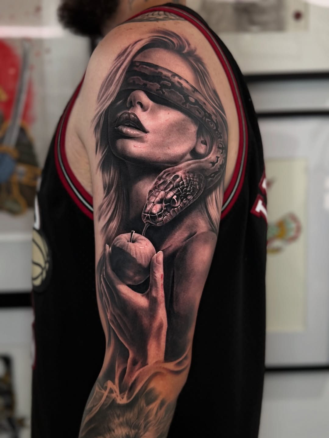 Hyper-realistic black-and-gray Eve with blindfold and serpent