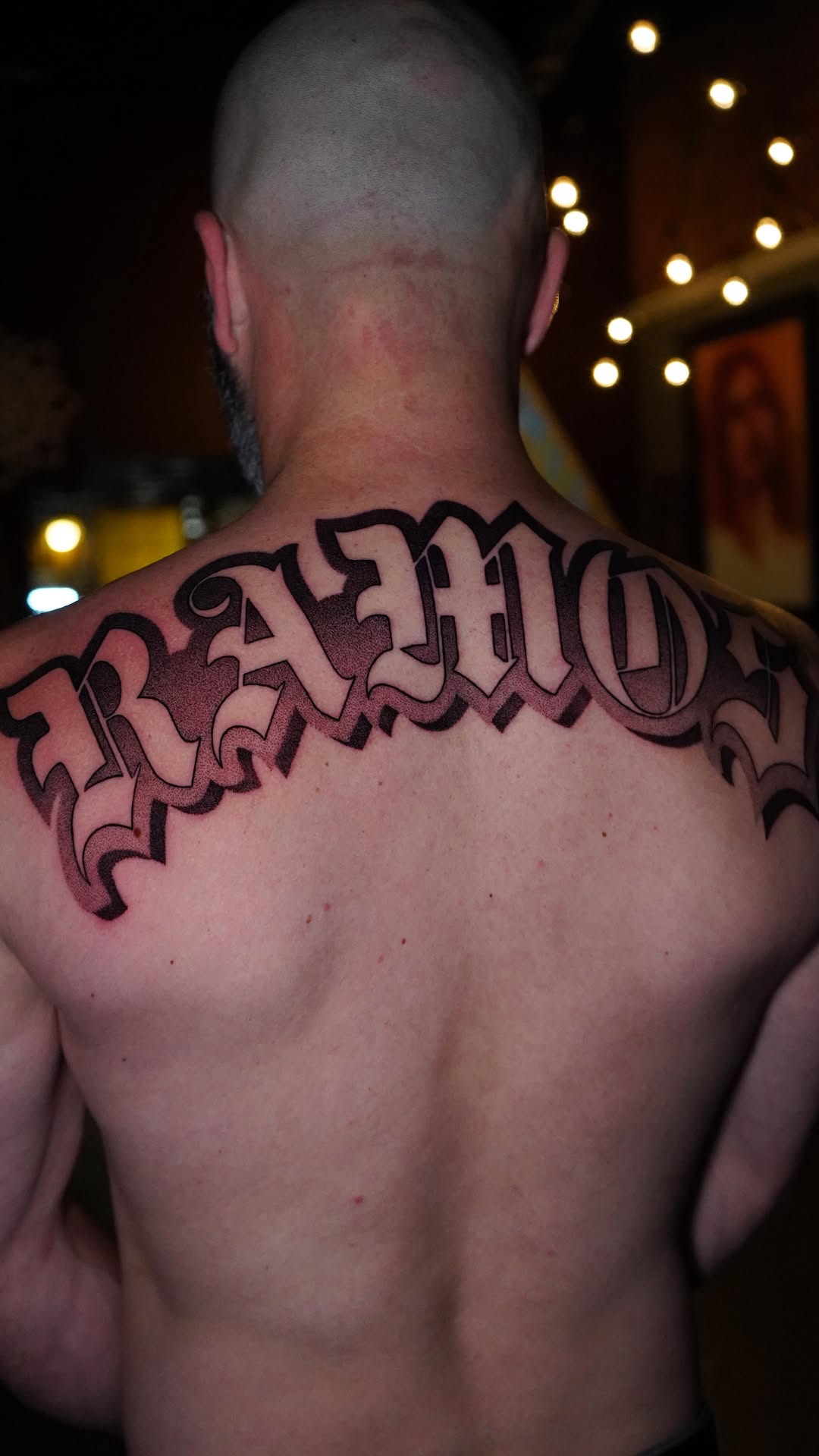 Bold blackletter script across the upper back