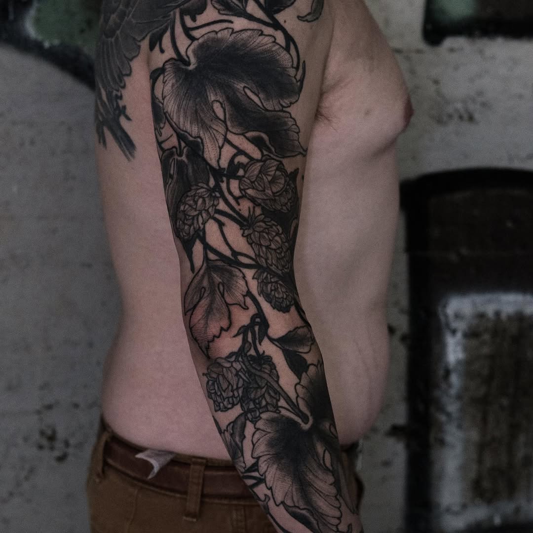 Intricate blackwork floral sleeve with bold outlines and shading