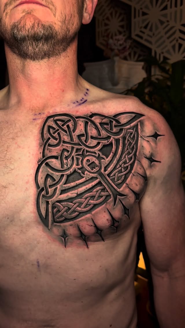 Bold blackwork Celtic knot hammer across the chest.