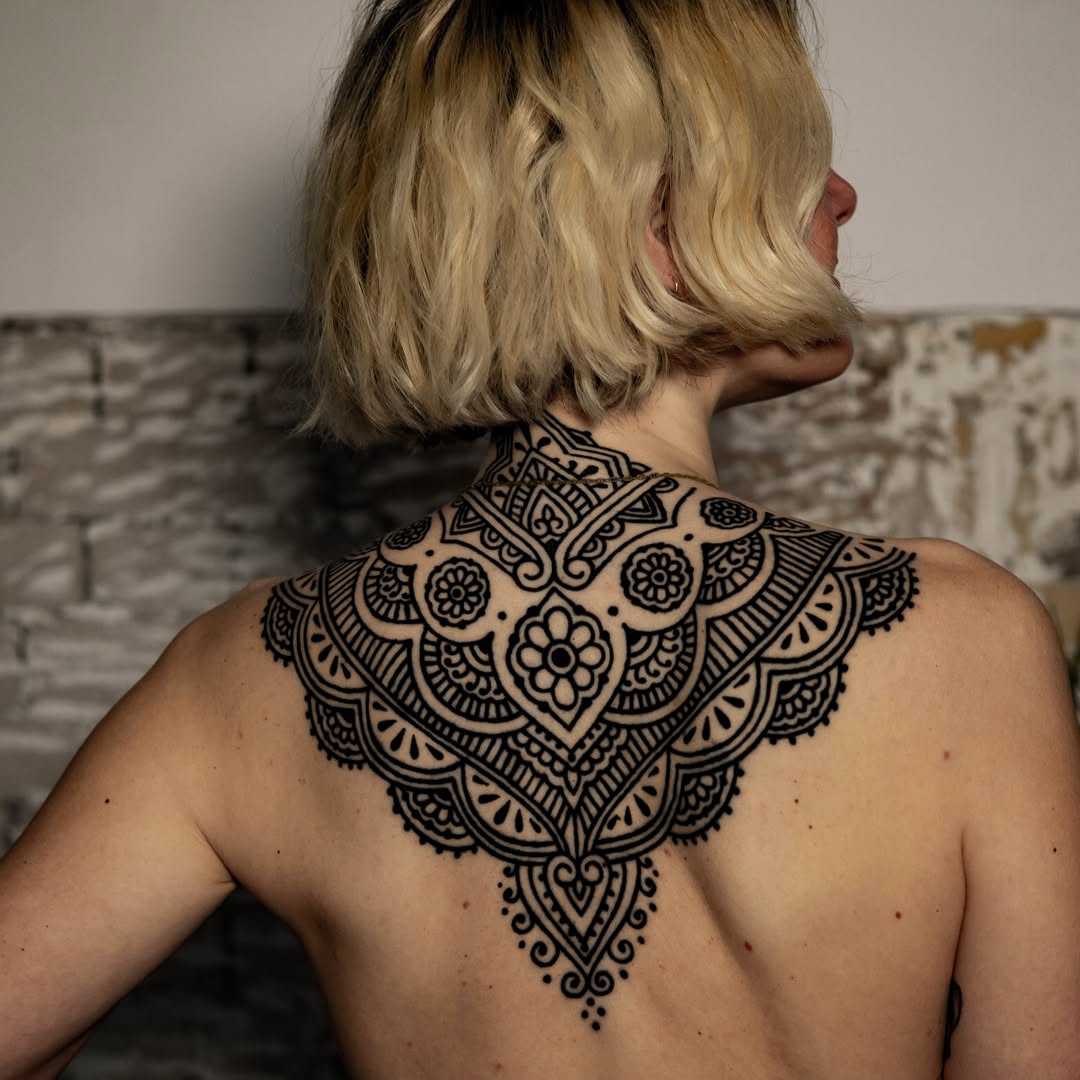 Intricate blackwork ornamental back piece with lace mandala