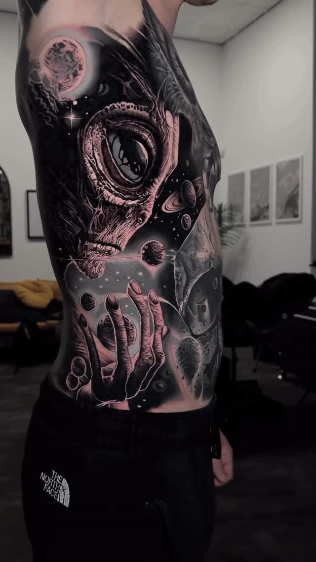 Glowing space-horror skull with reaching skeletal hand