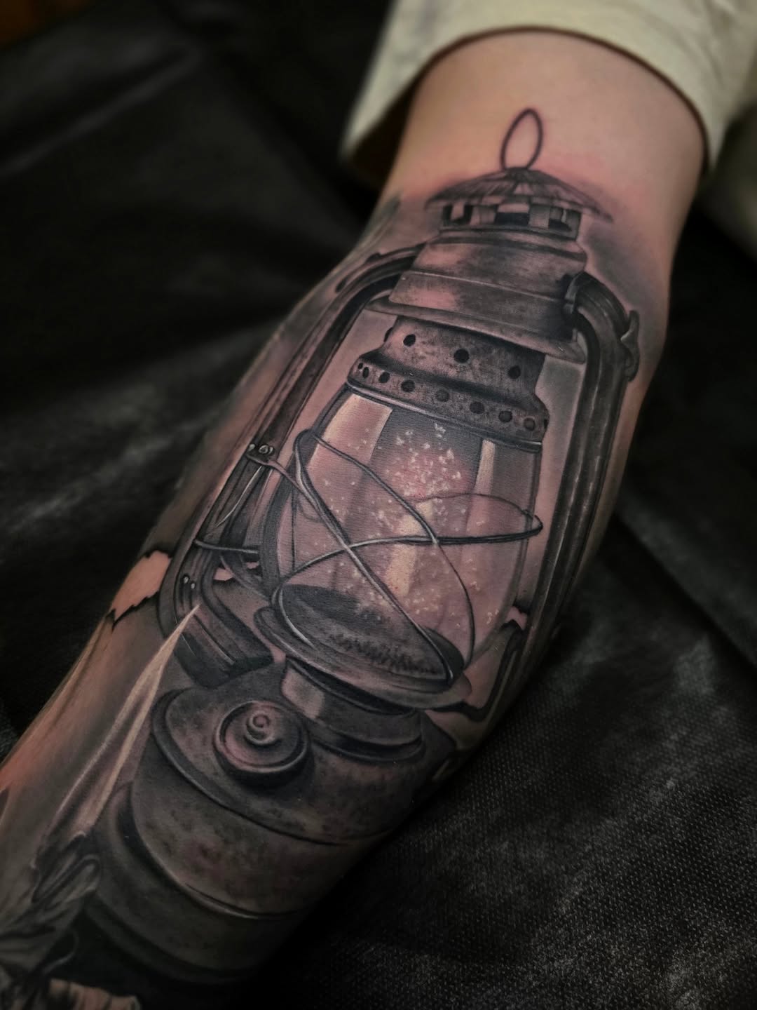 Hyper-detailed black-and-gray lantern with glass glow.