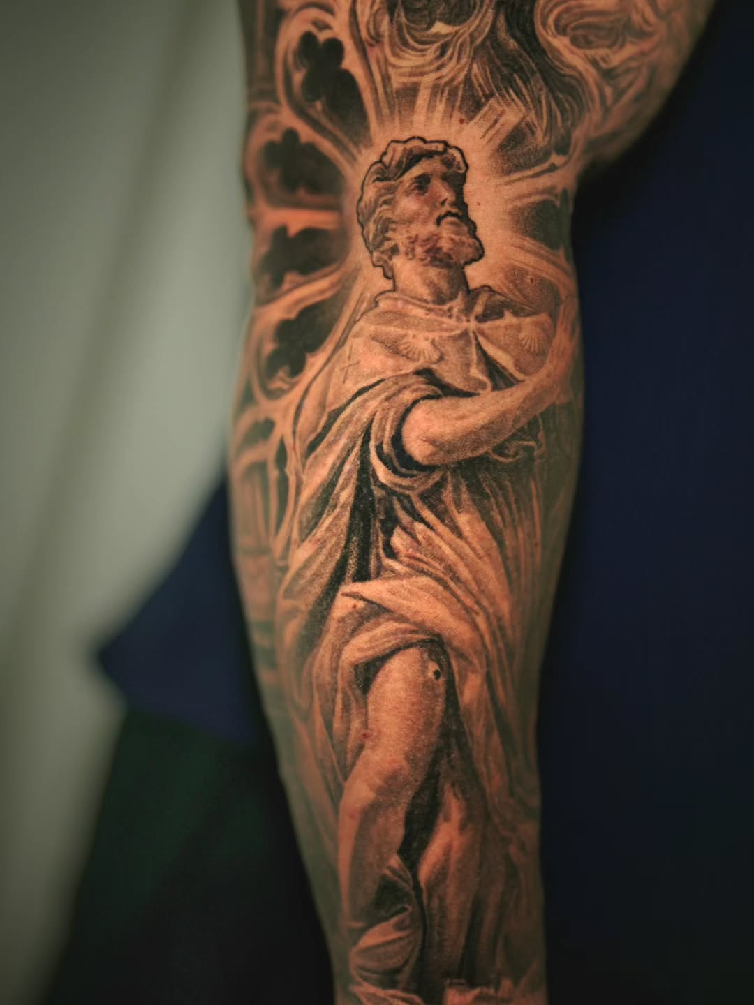 Saint Roch in dramatic black-and-gray realism, sculptural pose