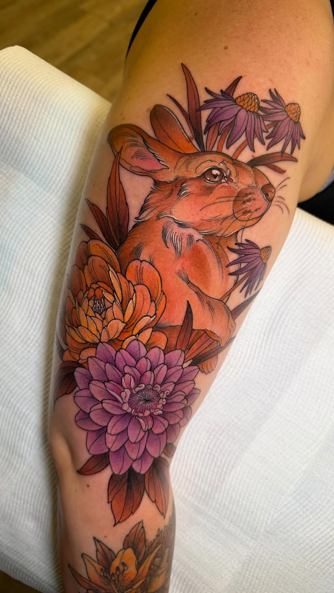 Autumn-toned bunny amid chrysanthemum and dahlia blooms, bold linework