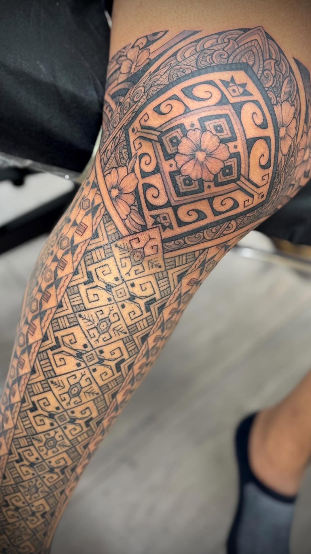 Dense geometric Polynesian-inspired leg sleeve with bold linework