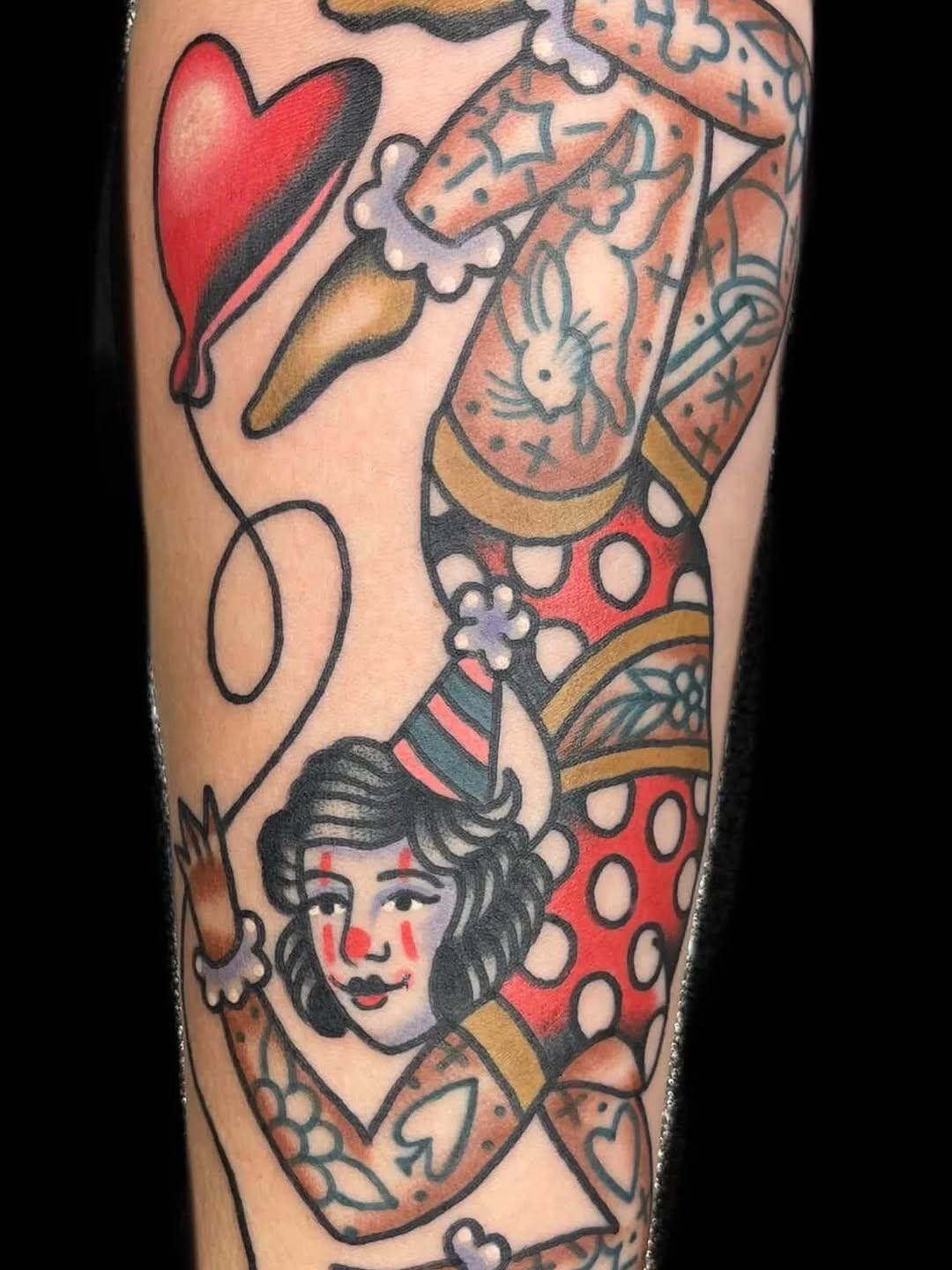 Bold traditional sleeve with playful clown-faced portrait.