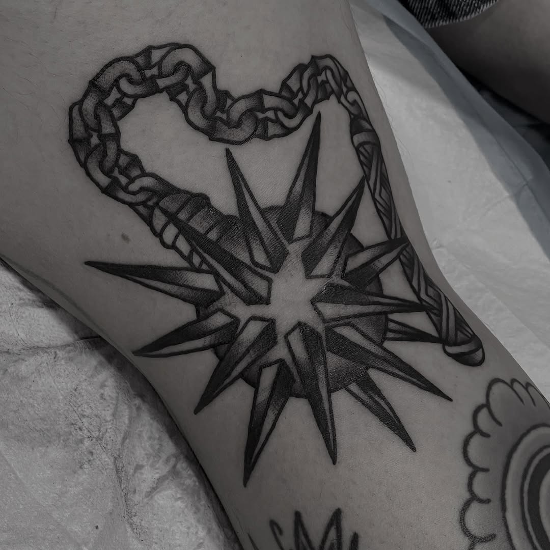 Bold angular compass-star with looping chain heart