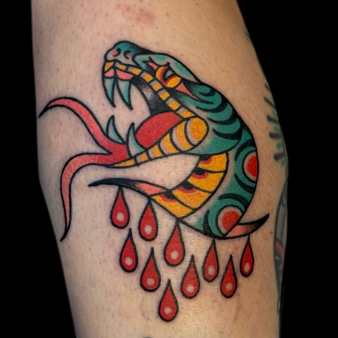 Bold traditional snake with teal scales and red droplets