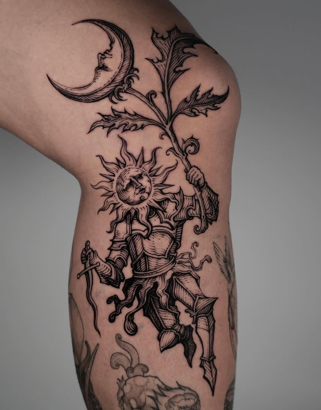 Engraved blackwork sun-figure with armored knight.