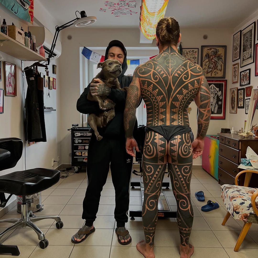 Massive geometric blackwork back tattoo with symmetrical motifs