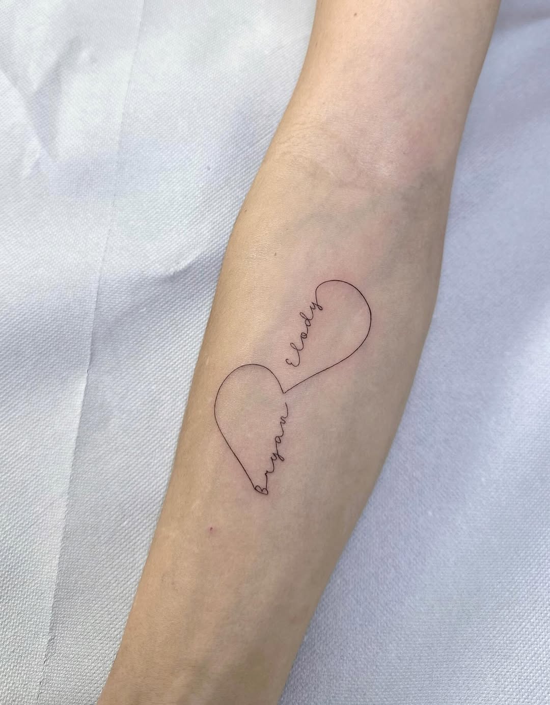 Delicate double-heart linework with cursive family love