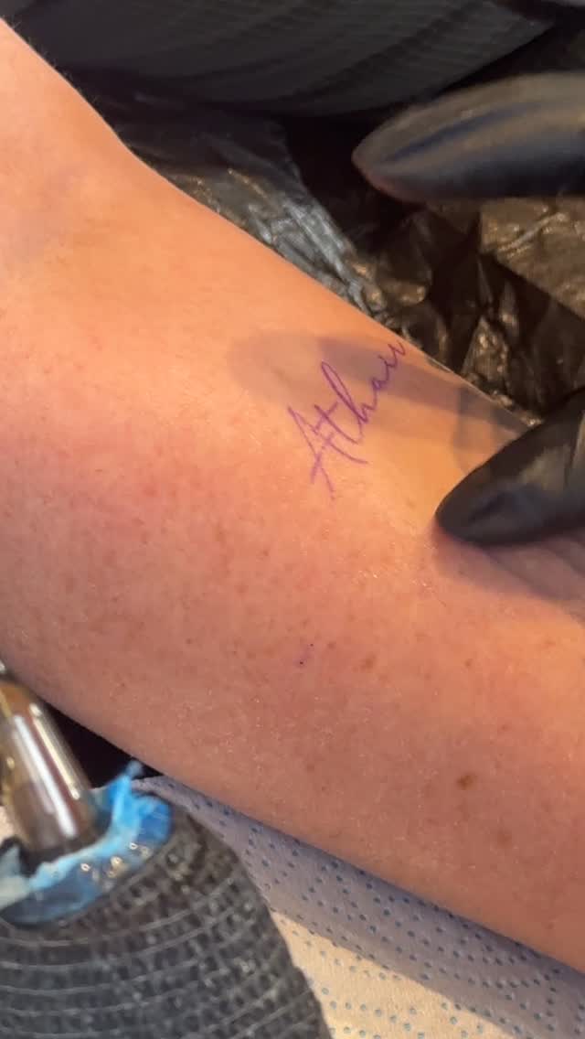 Delicate Gaelic word tattoo in fine-line script