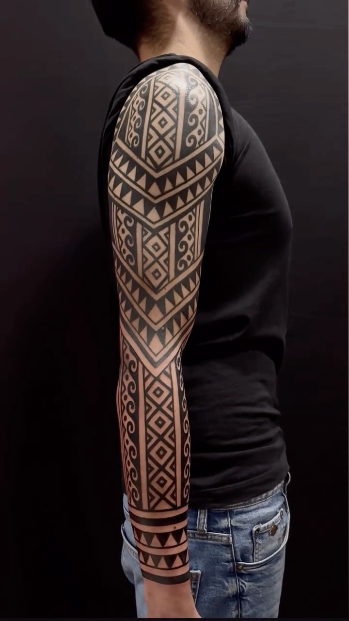 Bold blackwork tribal sleeve with Pre-Colombian geometric motifs