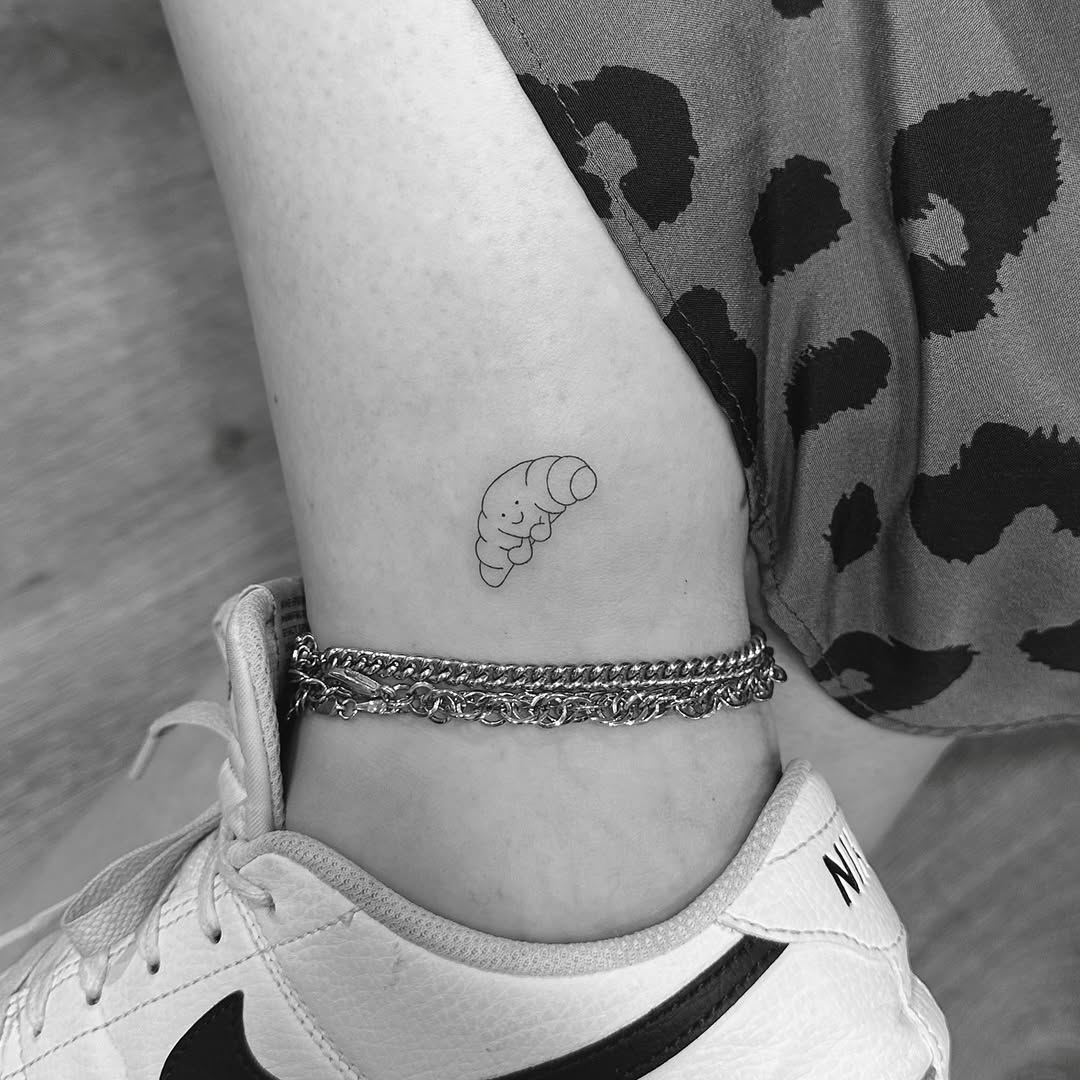 Tiny minimalist caterpillar with a cheerful face.