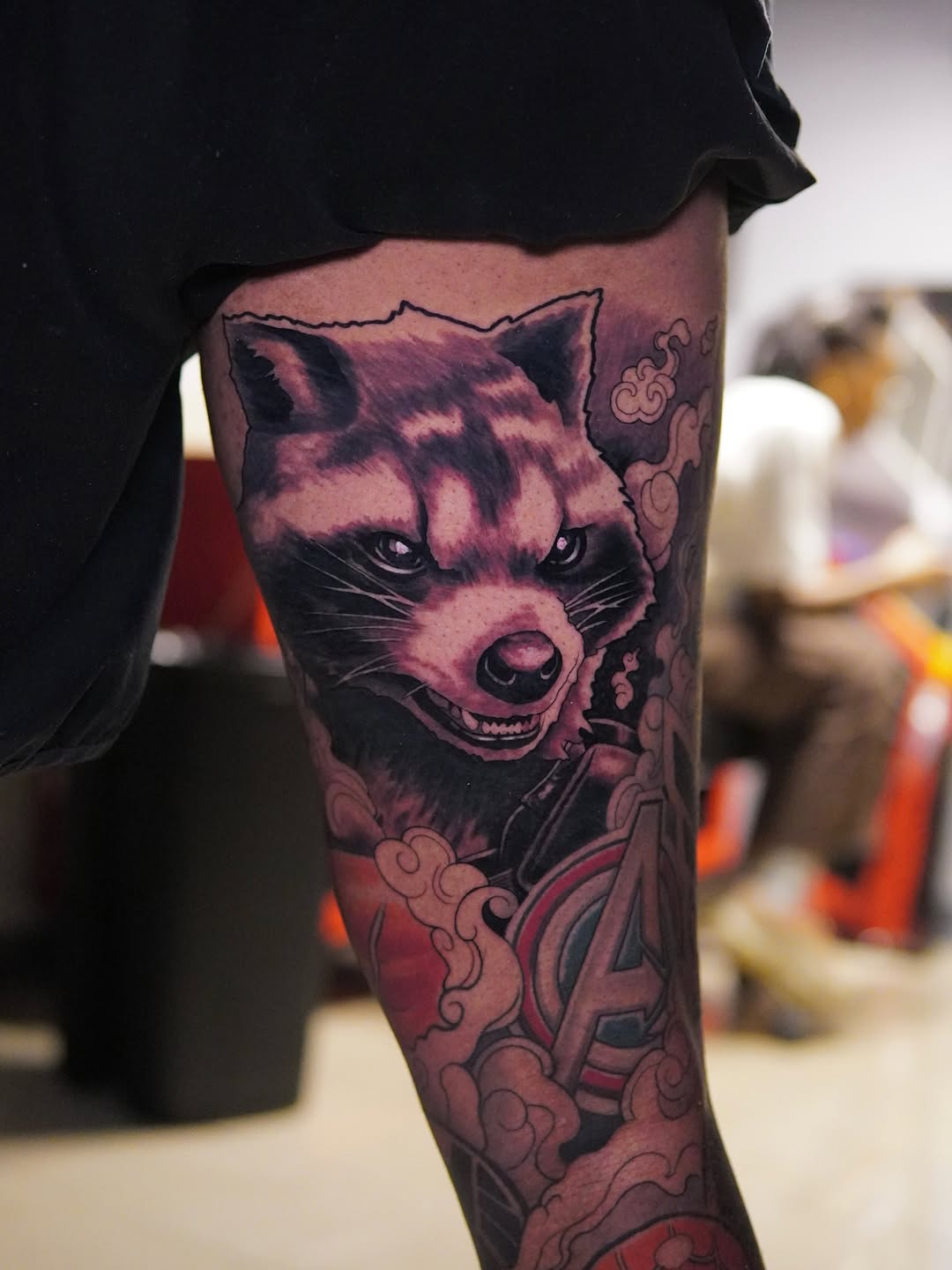 Bold snarling raccoon portrait; black-gray shading with pink highlights