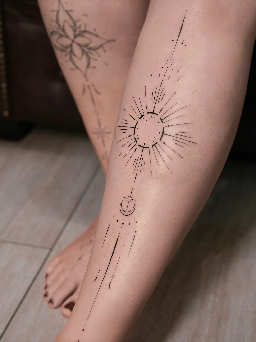 Minimal geometric sunburst with crescent moon and trailing lines