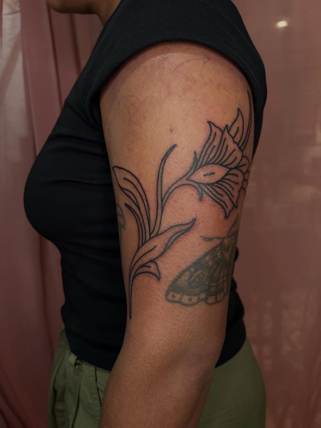 Symmetrical floral linework in bold black outlines.