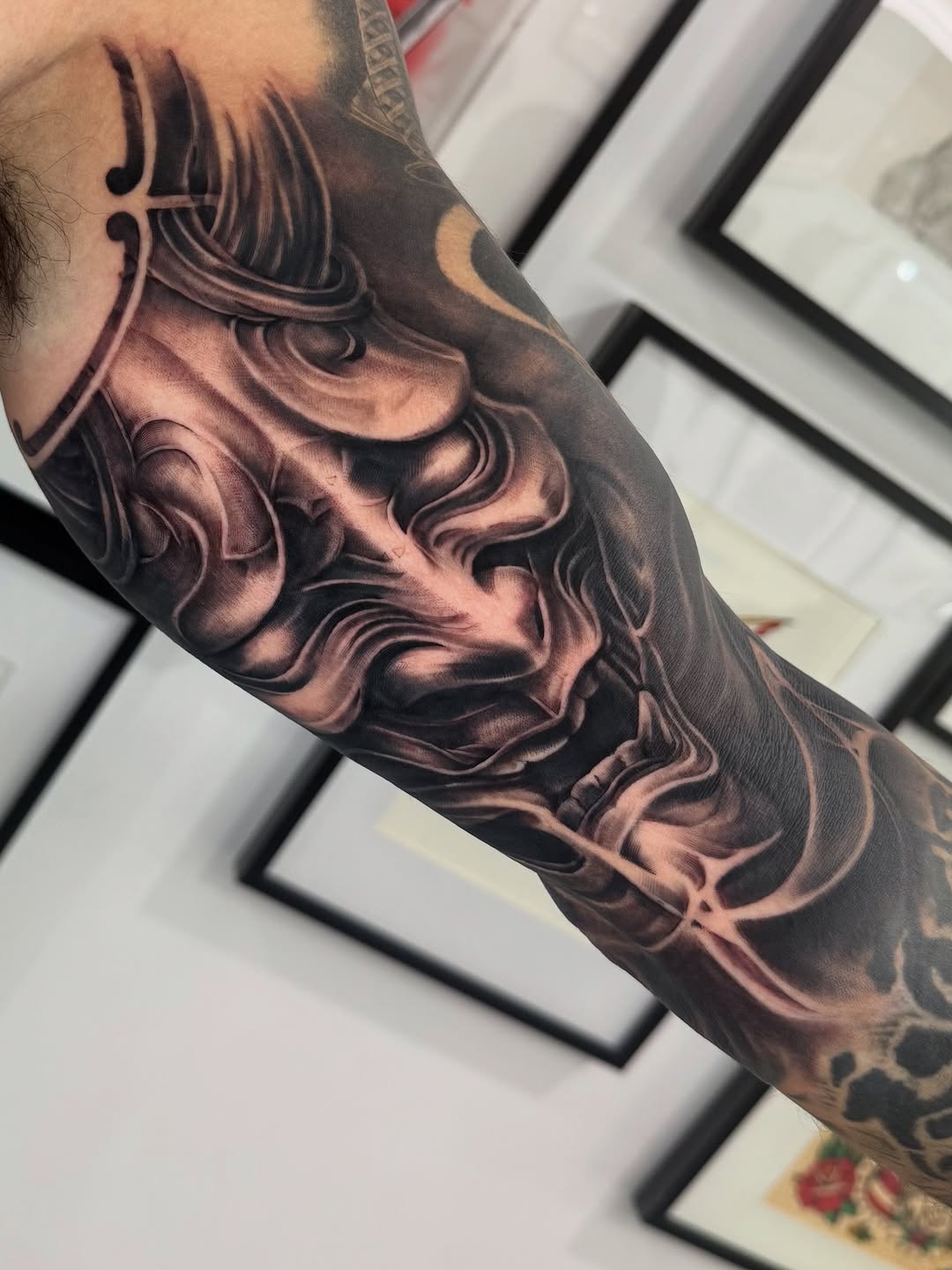Hannya-inspired black-and-gray inner-bicep swirl with dramatic shading