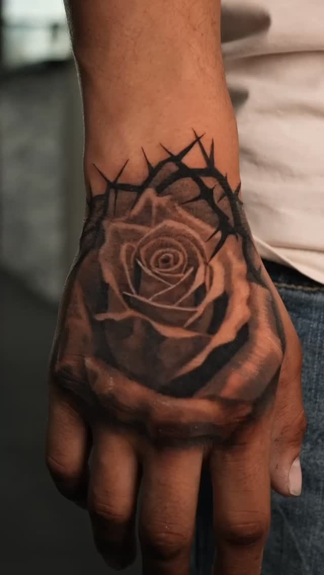 Striking black-and-gray rose with thorn crown.