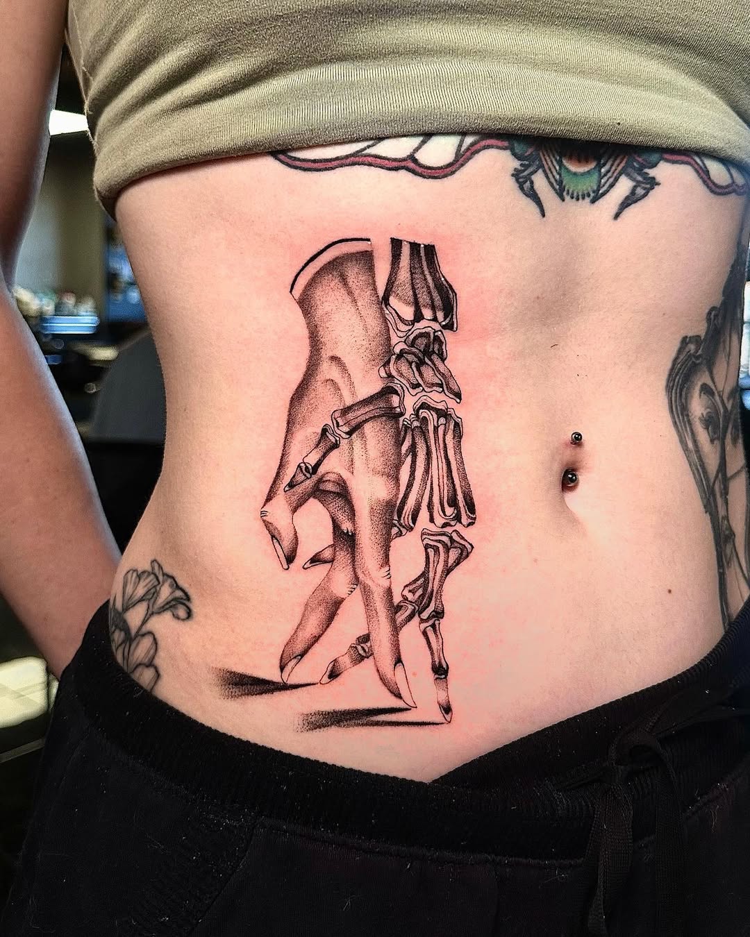 Intricate skeletal anatomy tattoo in bold blackline shading