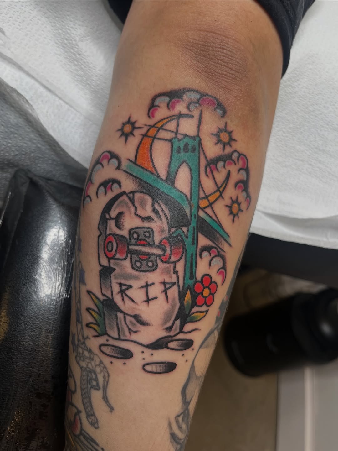 Whimsical tombstone and bridge scene with bright color.