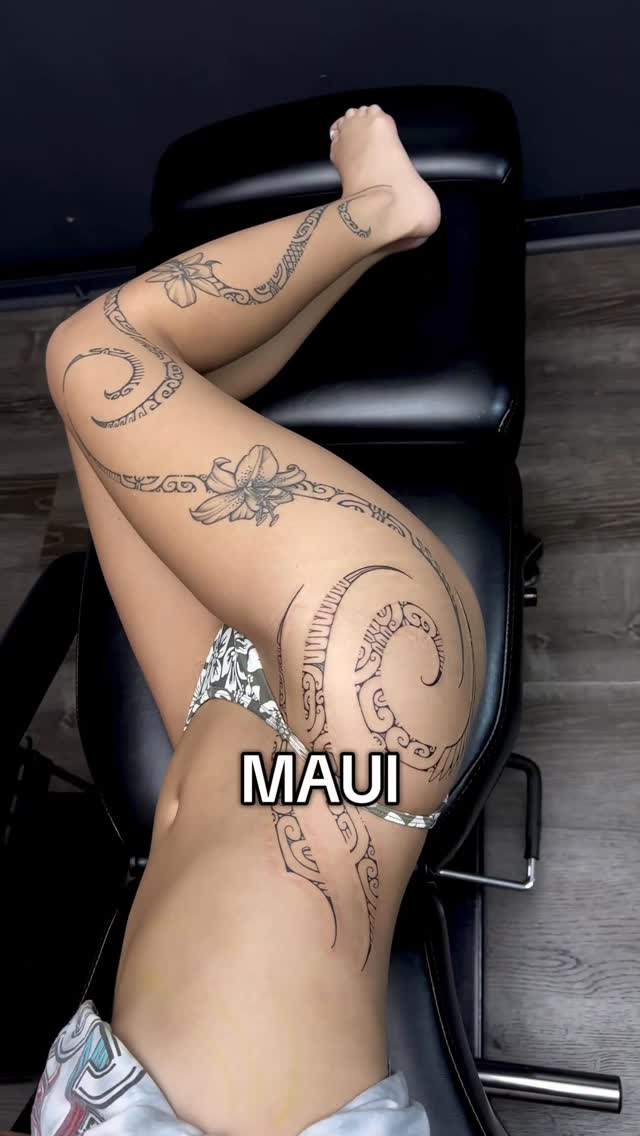 Polynesian-inspired leg sleeve with spirals and floral motifs.