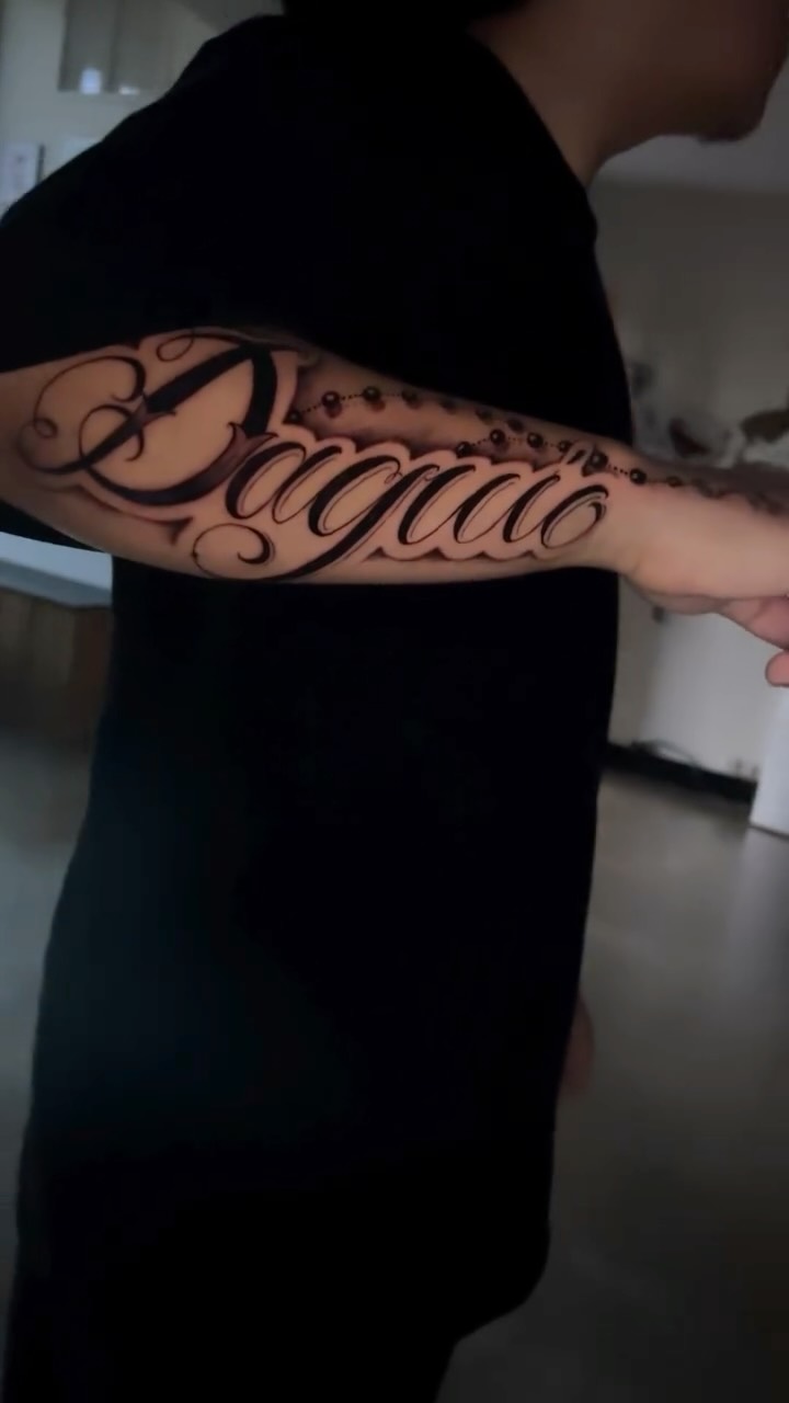 Elegant freehand script forearm with rosary bead accents