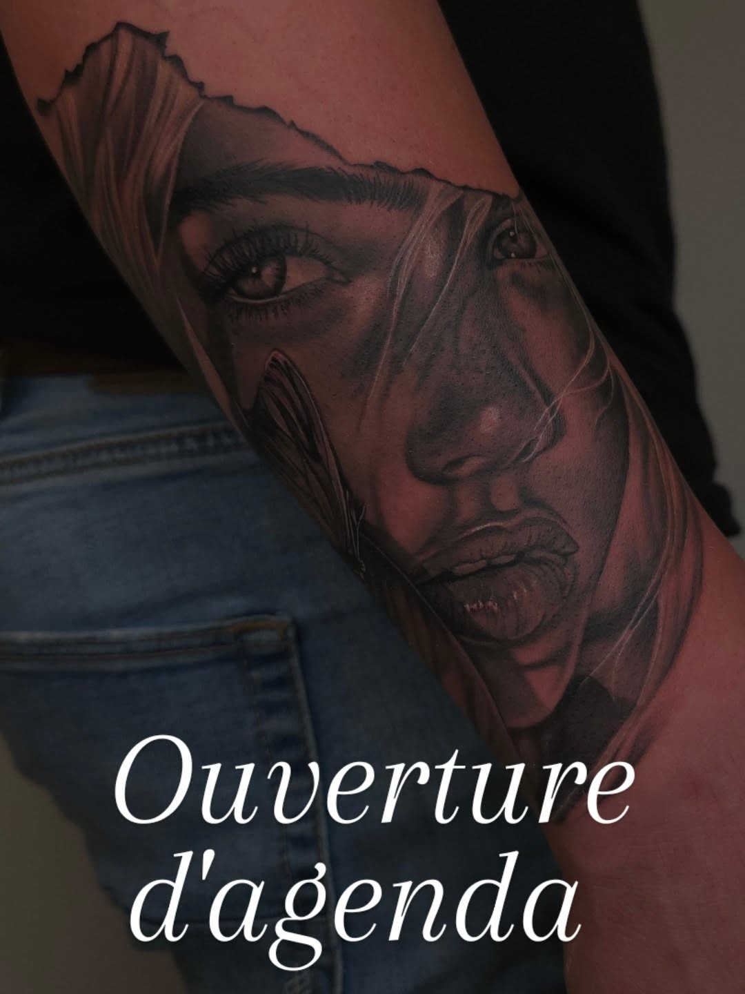 Hyper-realistic black-and-gray female portrait on forearm.