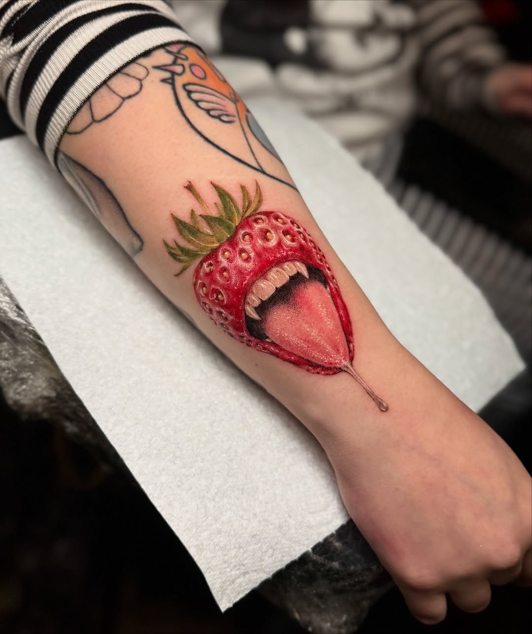 Juicy strawberry with a menacing, open-mouthed bite.