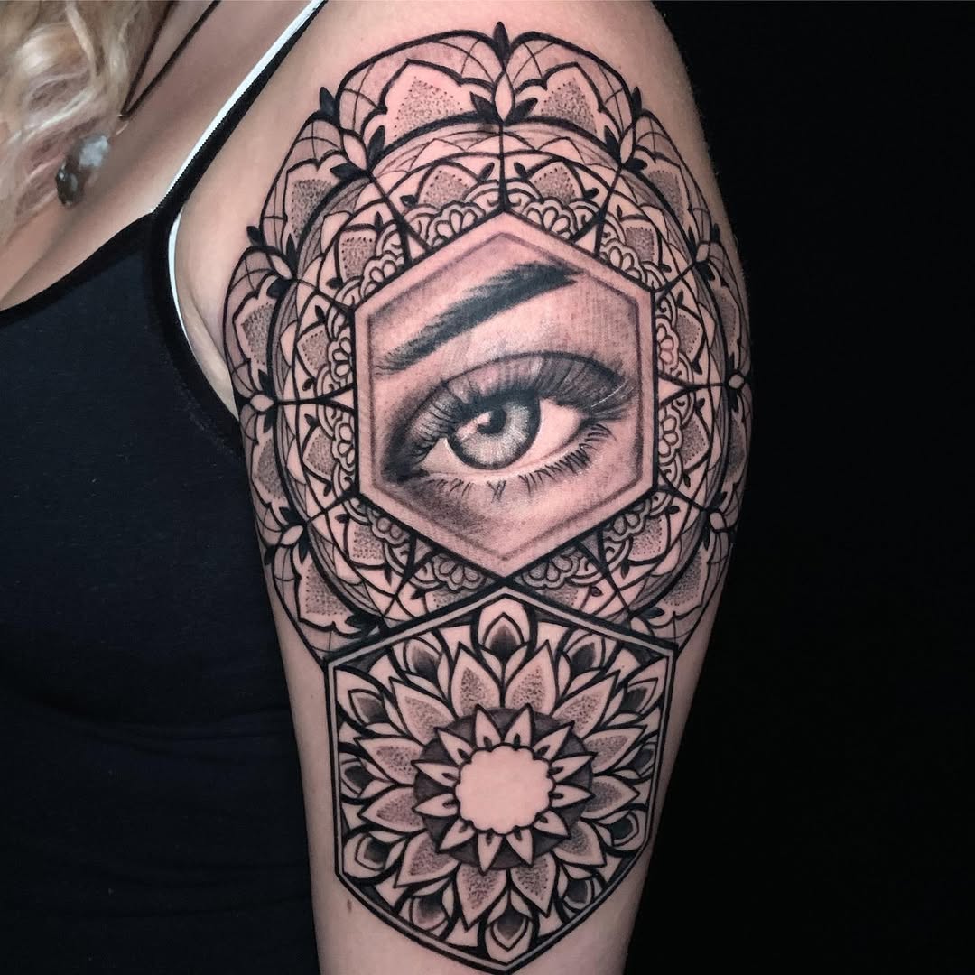 Intricate geometric mandala surrounds a striking central eye.