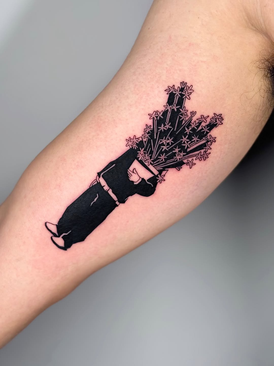 Bold black silhouette delivering a bouquet of pink flowers