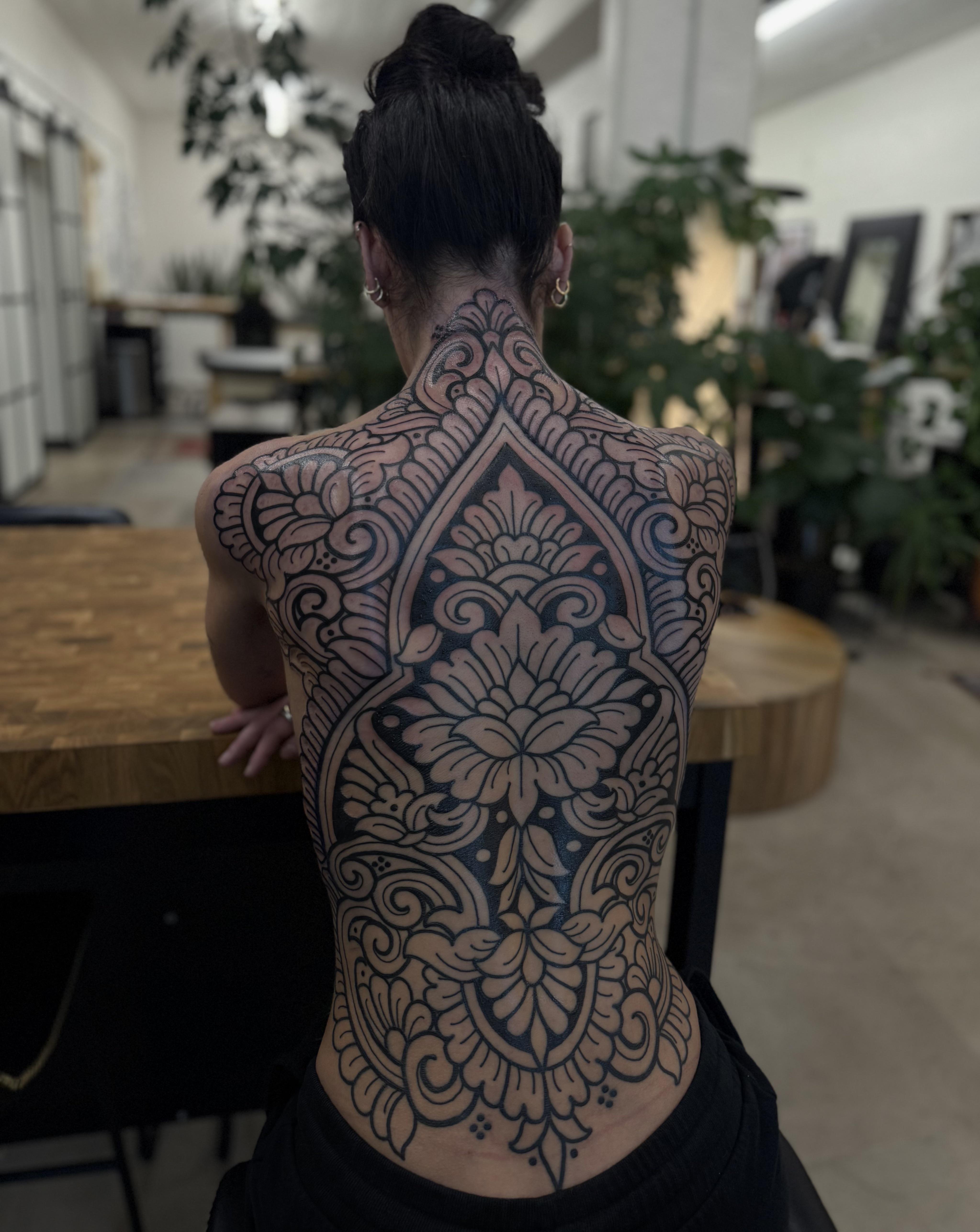 Intricate ornamental back piece with lush floral lattice