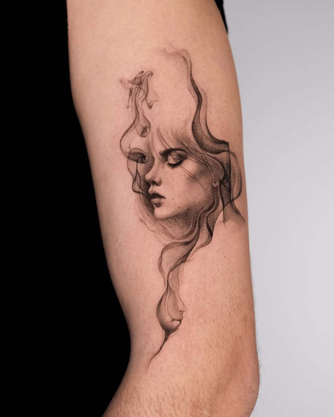 Dreamy female portrait emerging from flowing smoke lines