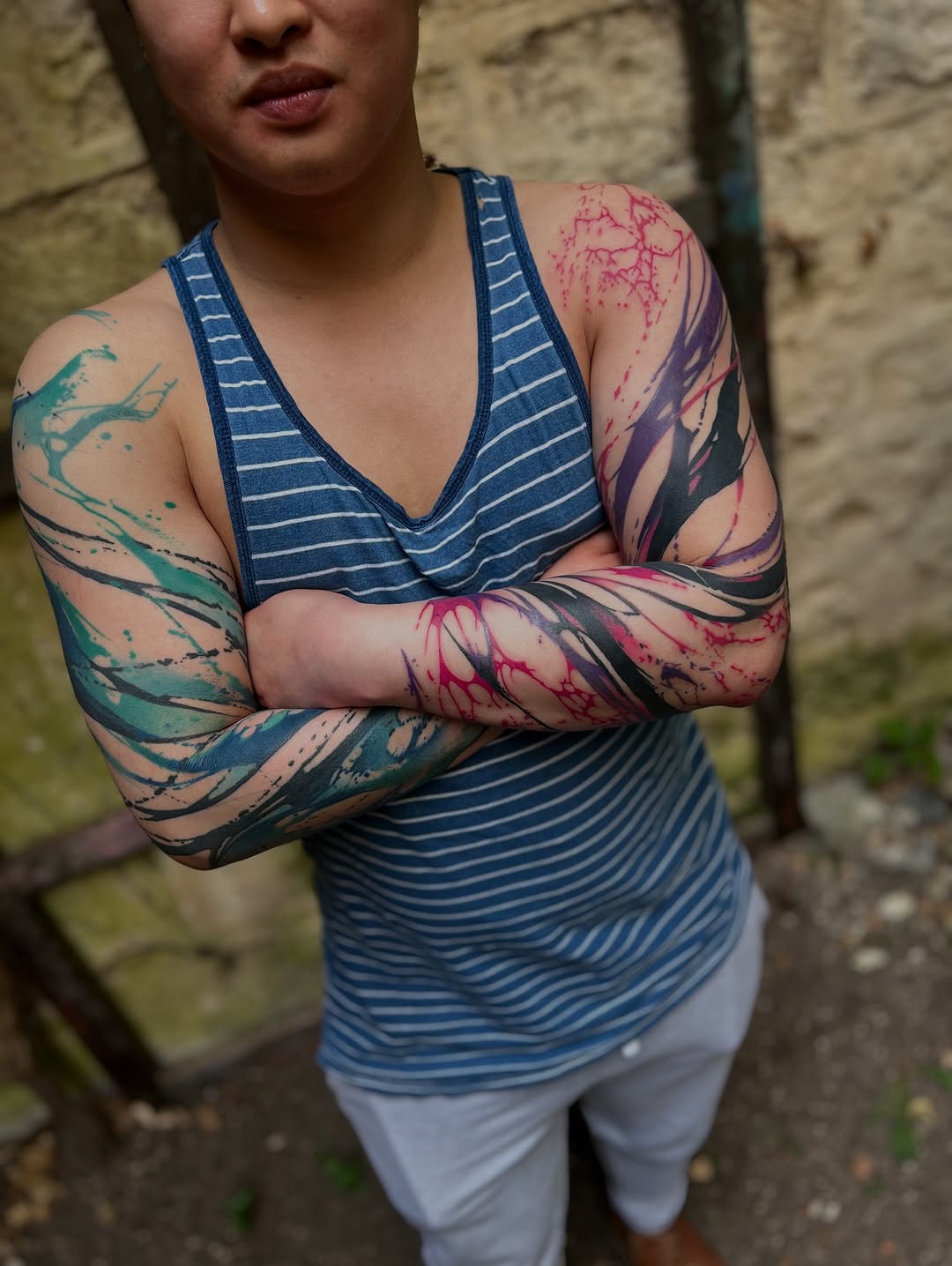 Vibrant split-sleeve abstract tattoos in bold color.