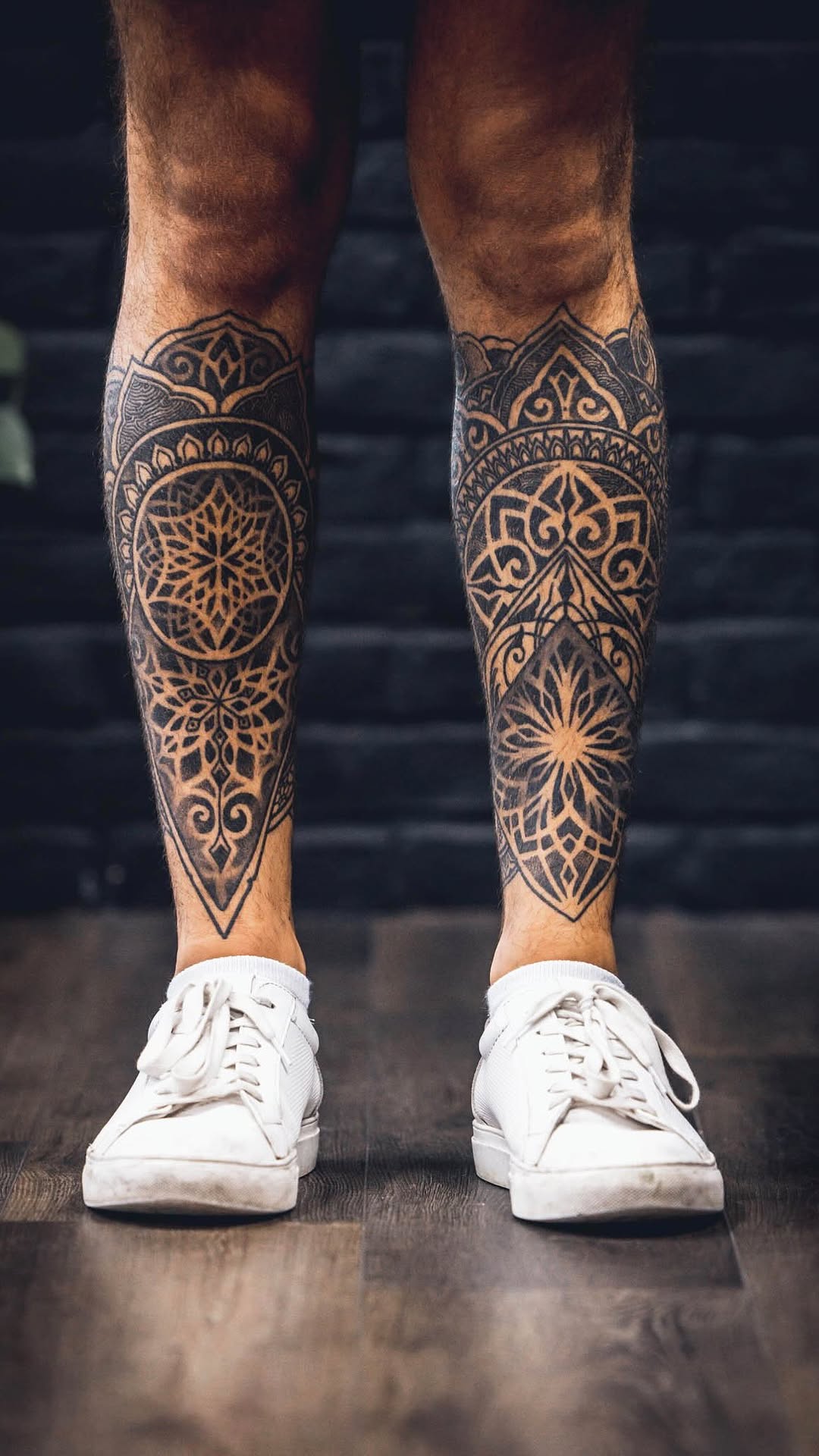 Intricate blackwork mandala leg sleeves with bold linework.