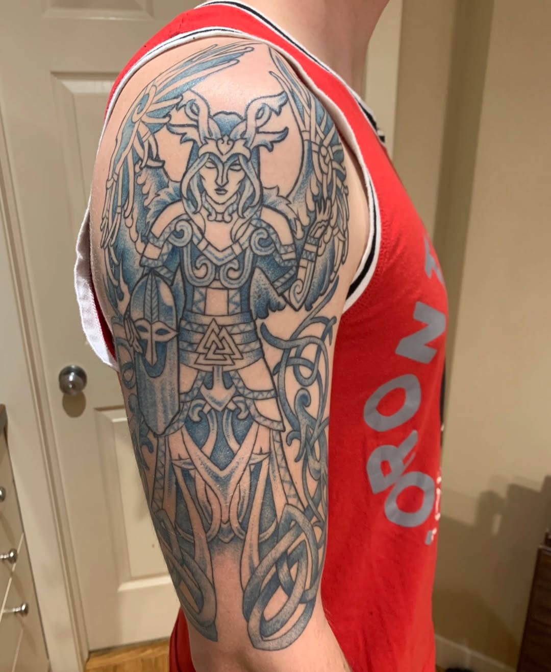 Intricate Valkyrie in bold blue linework with knotwork