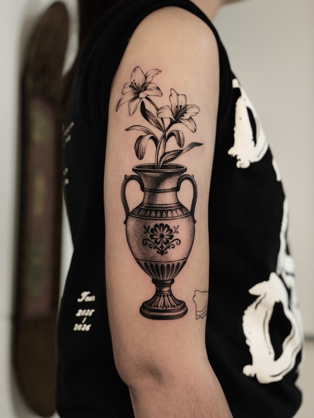 Elegant blackwork vase with blooming lilies, ornate detailing